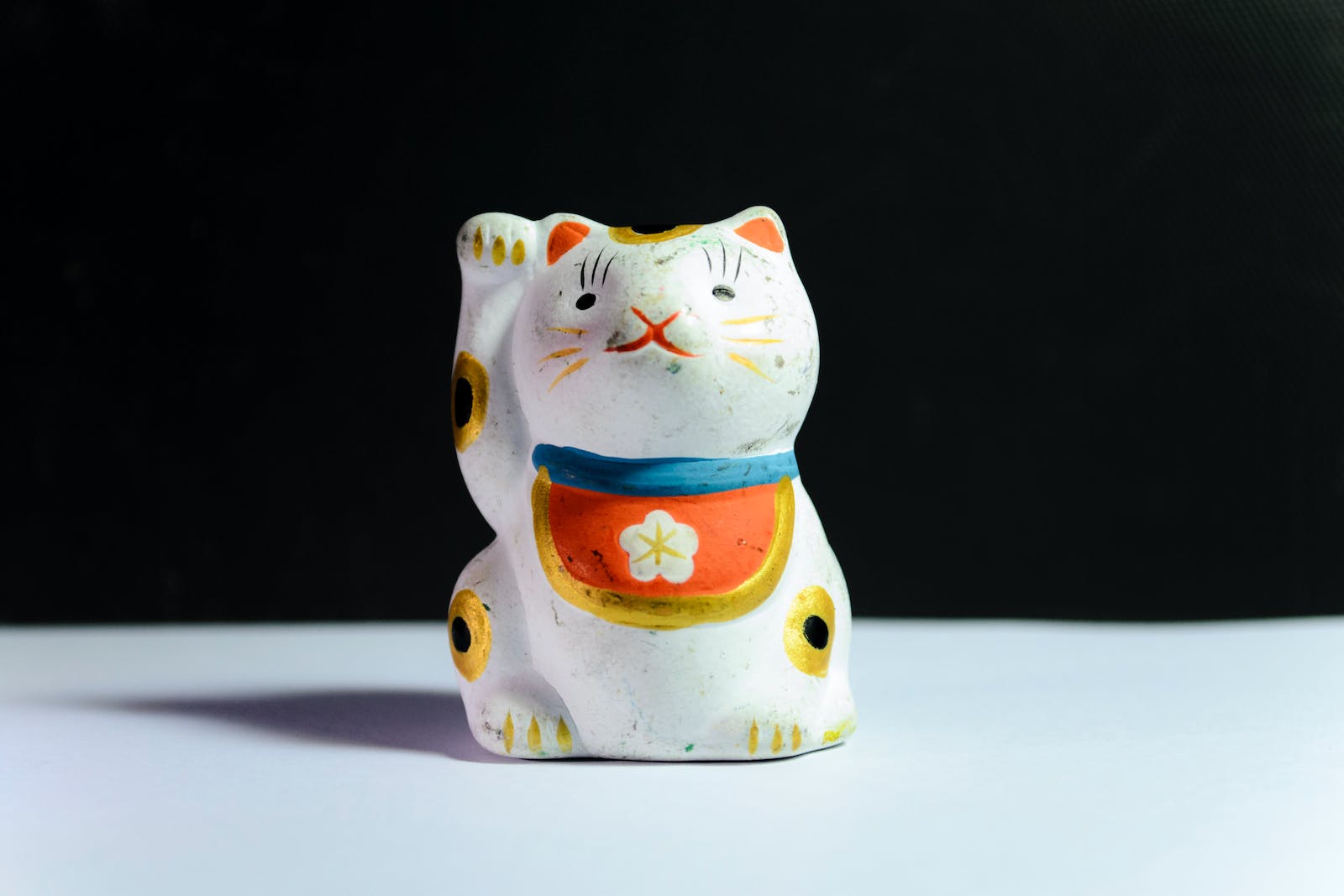 Maneki-Neko Figurine On White Surface